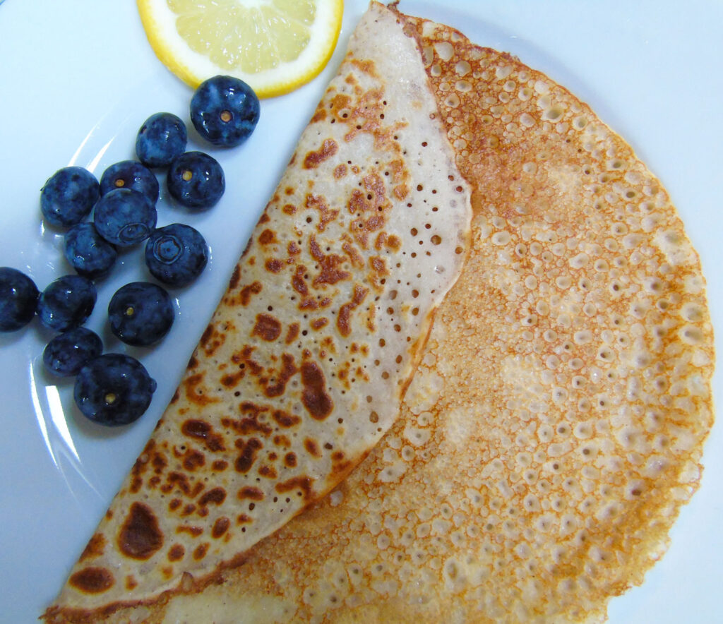 Pancake on a plate with blueberries and lemon