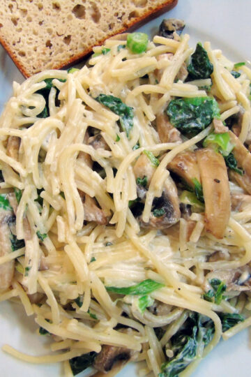 Mushroom noodles with spinach and creme fraiche on plate