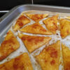Baked puff pastry triangles with red pesto