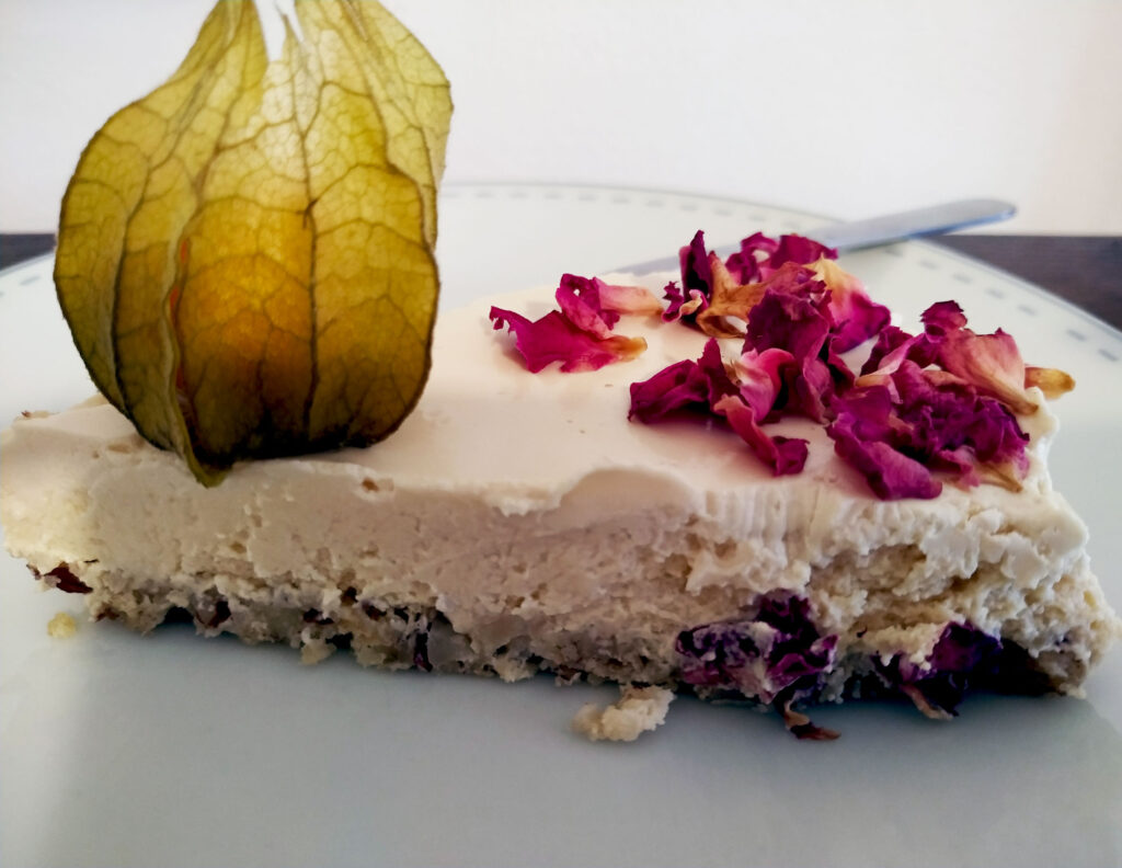 Manhattan cheesecake slice on a nut base, placed on a plate